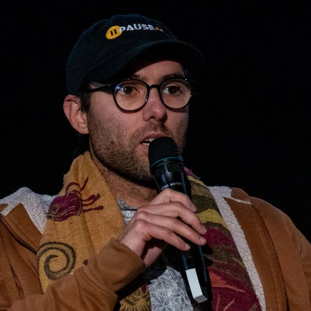 Maxime Fournes speaking on stage